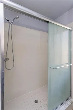 a bathroom with a glass shower door