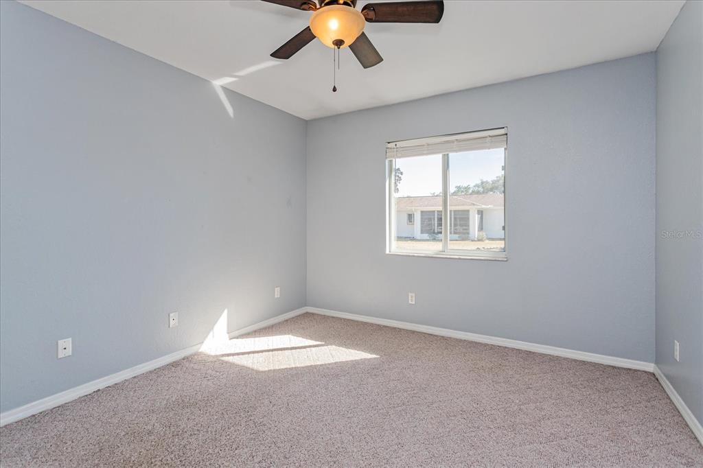 6114 Southwest 104th Street Ocala, FL 34476 - Photo 20 of 28 wooden floor in an empty room with a window
