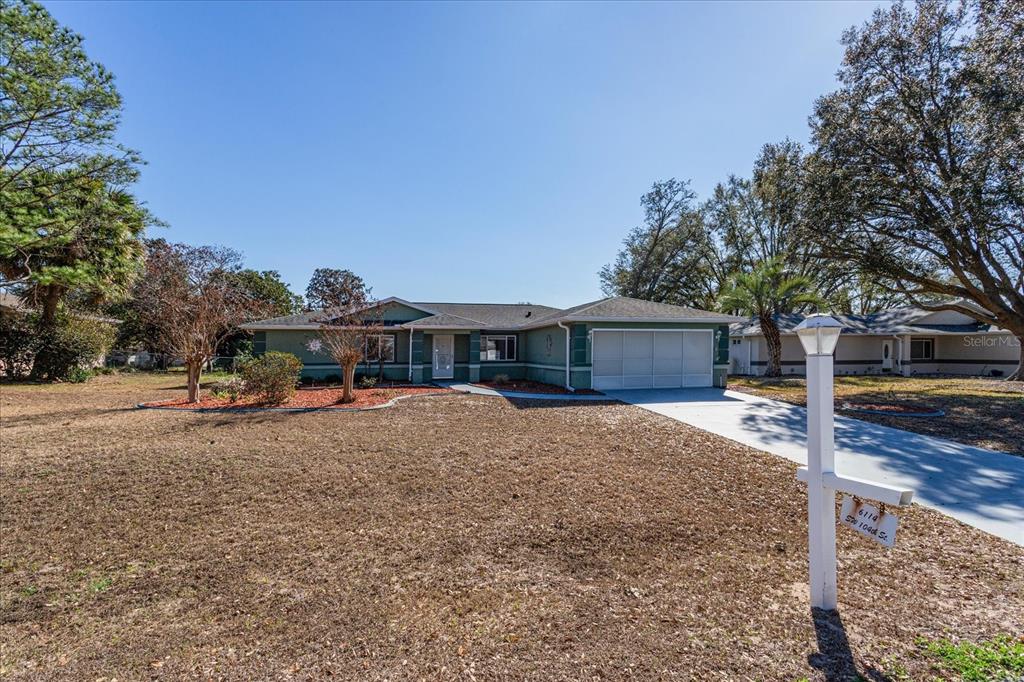 6114 Southwest 104th Street Ocala, FL 34476 - Photo 2 of 28 a view of a house with a yard
