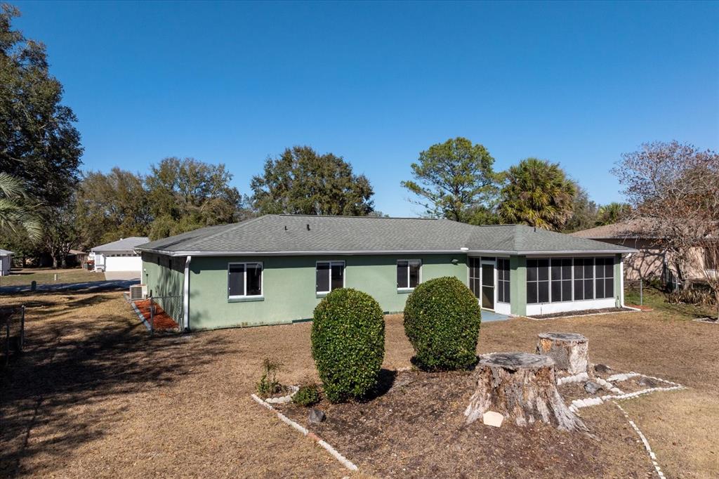 6114 Southwest 104th Street Ocala, FL 34476 - Photo 26 of 28 a front view of a house with garden