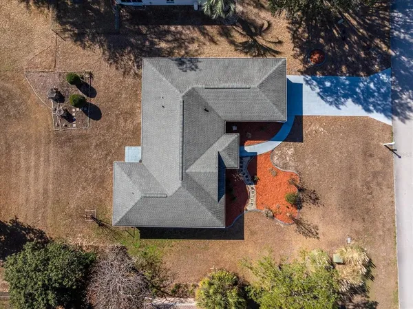 an aerial view of a house with a yard