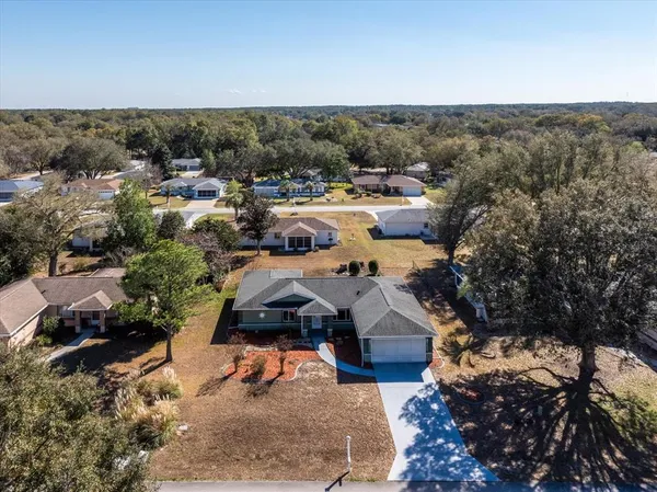 an aerial view of a houses with a yard