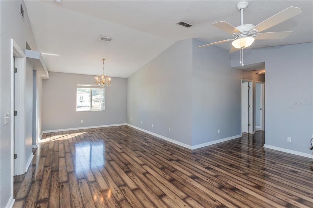 6114 Southwest 104th Street Ocala, FL 34476 - Photo 6 of 28 wooden floor in an empty room with a window