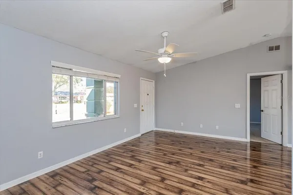 wooden floor in an empty room with a window
