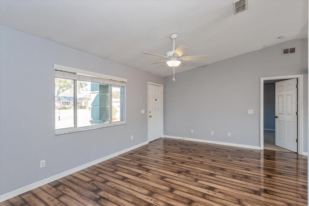 6114 Southwest 104th Street Ocala, FL 34476 - Photo 8 of 28 wooden floor in an empty room with a window