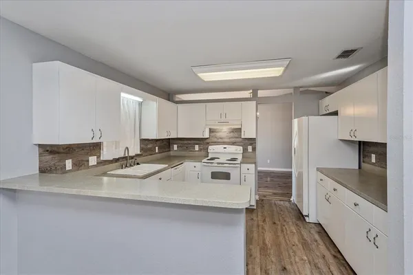 a kitchen with stainless steel appliances a sink stove and refrigerator
