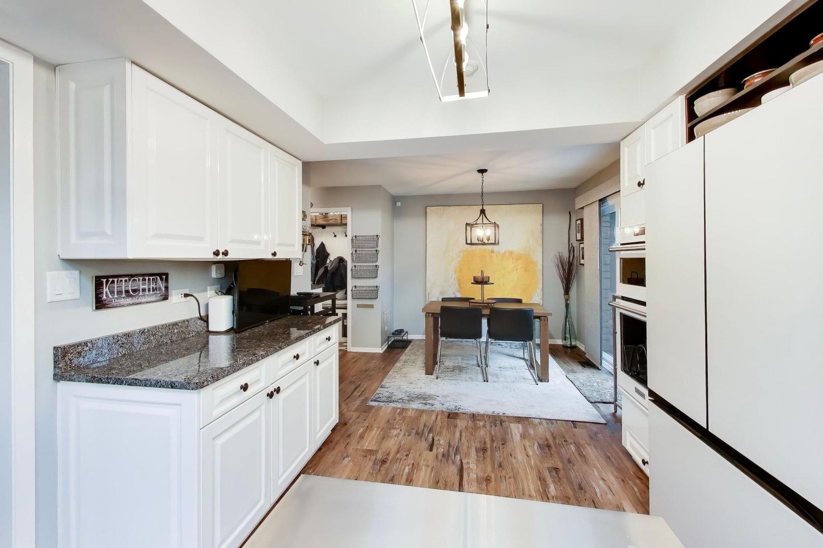 22 Rodeo Drive Burr Ridge, IL 60527 - Photo 13 of 46 a kitchen with stainless steel appliances granite countertop a refrigerator a sink dishwasher a stove and white countertops with wooden floor