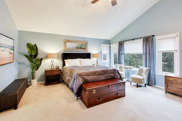 a bedroom with a bed and large window