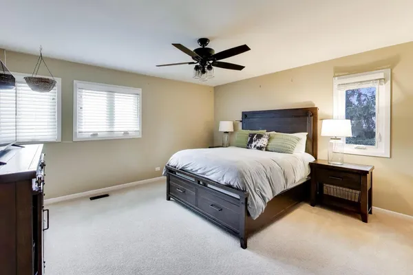 a bed sitting in a bedroom next to a window
