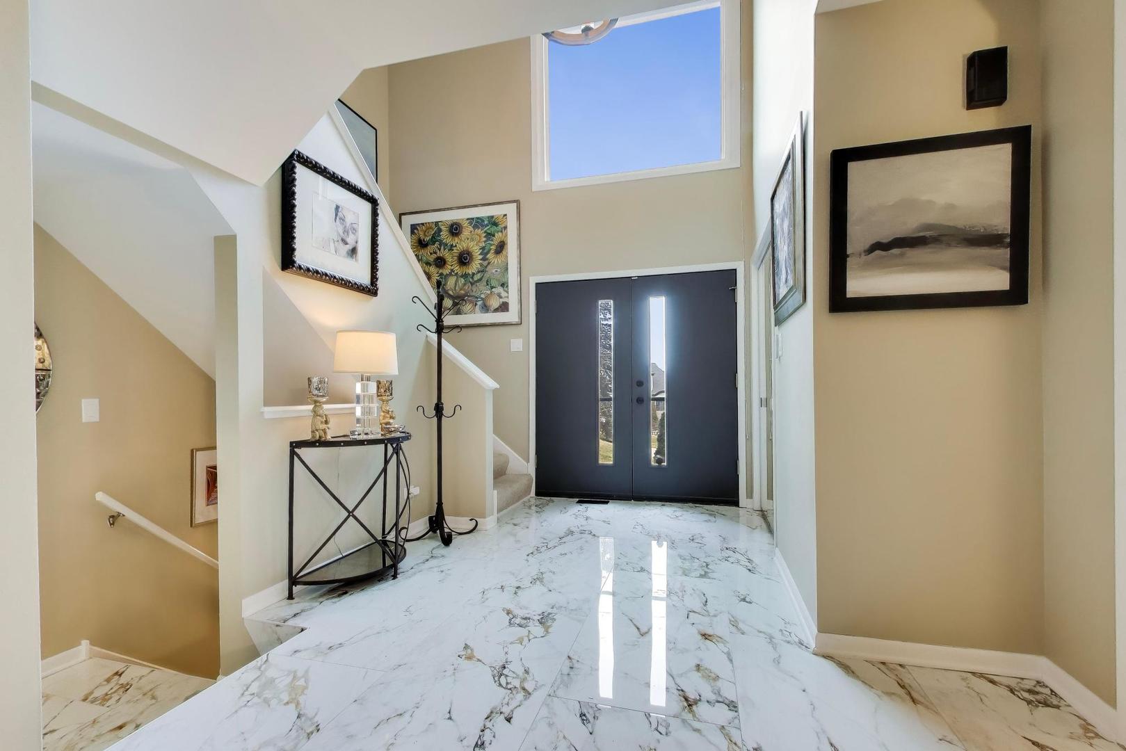 22 Rodeo Drive Burr Ridge, IL 60527 - Photo 3 of 46 a view of a hallway with paintings on the wall