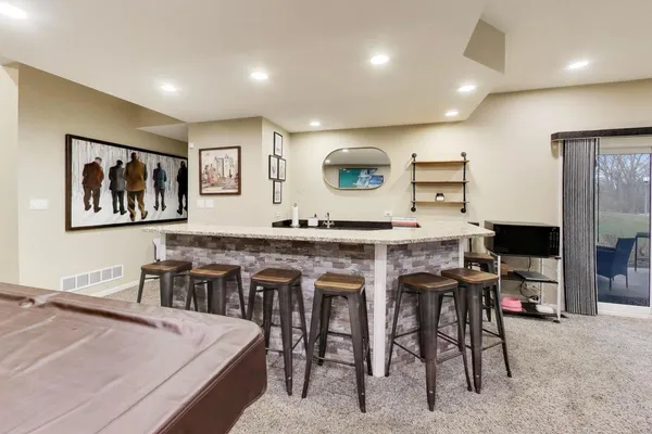 a living room with stainless steel appliances kitchen island granite countertop furniture and a view of kitchen
