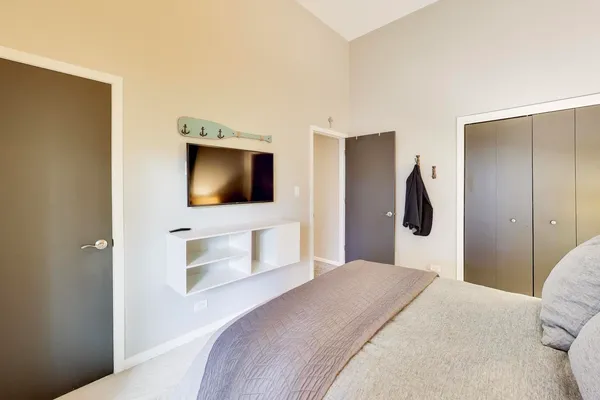 a bedroom with a bed and a flat screen tv