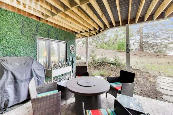 a view of a balcony with table and chairs with wooden floor and fence