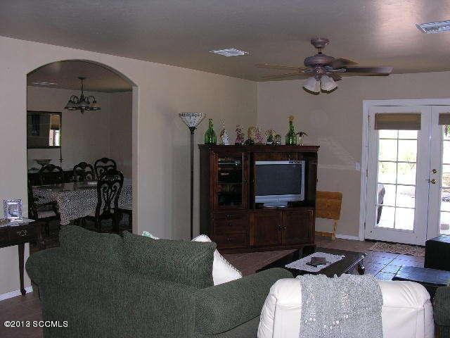 407 Camino Osito Rio Rico, AZ 85648 - Photo 16 of 23 a living room with furniture and a flat screen tv