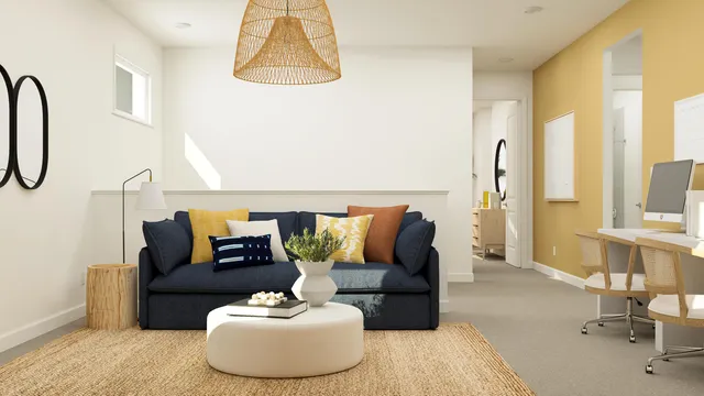 a living room with furniture and a white wall