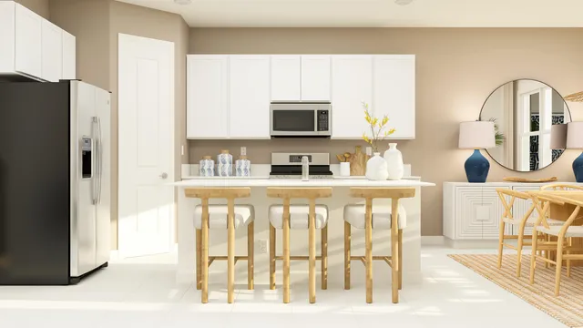 a kitchen with granite countertop a refrigerator and a sink