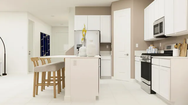 a kitchen with a refrigerator and white cabinets