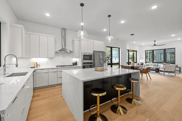a kitchen with counter space sink stove and cabinets