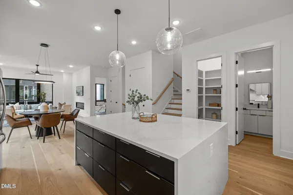 an open kitchen with a table and chairs