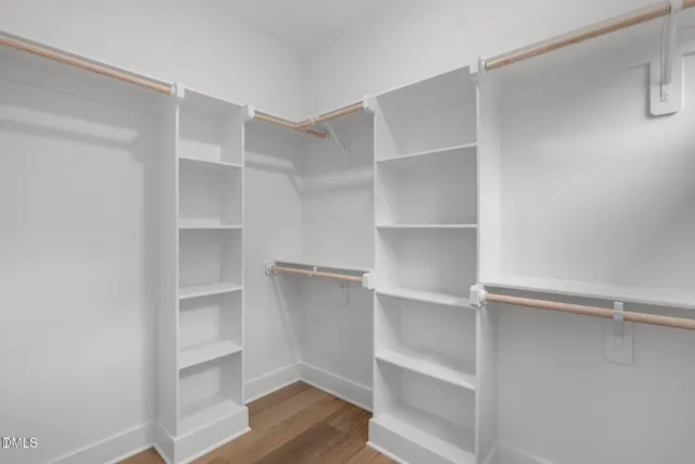 a view of walk in closet with empty racks