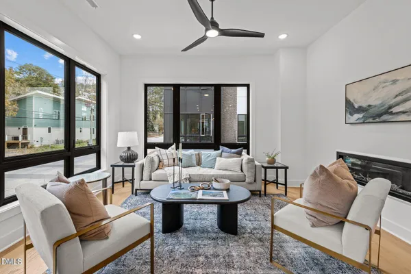 a living room with furniture and large windows