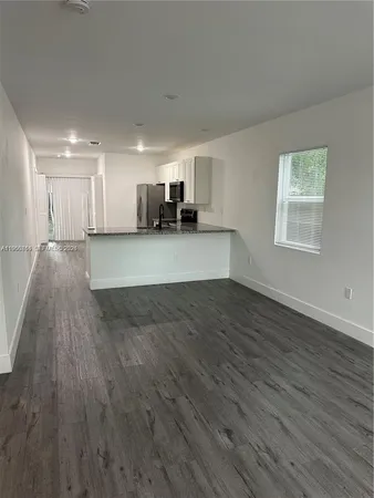 a view of a kitchen and wooden floor