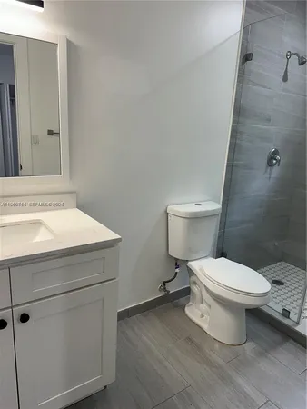 a bathroom with a toilet sink and a shower