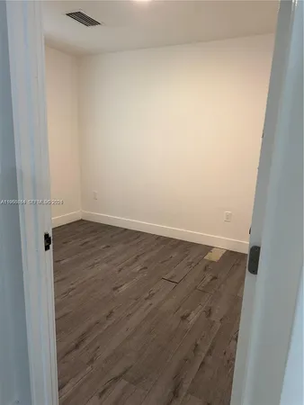an empty room with wooden floor