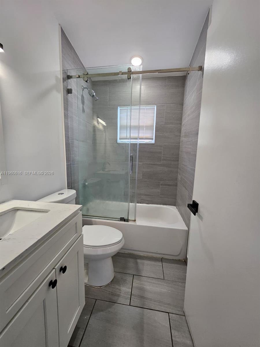 224 Northwest 57th Street, Unit B Miami, FL 33127 - Photo 35 of 40 a bathroom with a sink a toilet and shower
