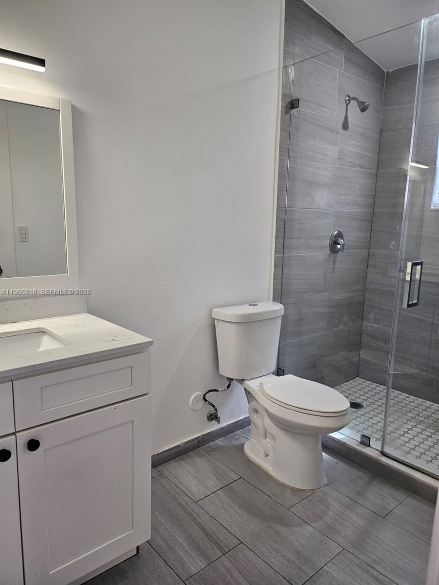 224 Northwest 57th Street, Unit B Miami, FL 33127 - Photo 38 of 40 a bathroom with a toilet and a sink