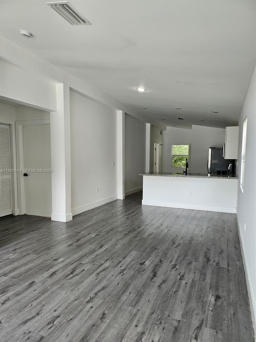 224 Northwest 57th Street, Unit B Miami, FL 33127 - Photo 40 of 40 a view of a big room with wooden floor and windows