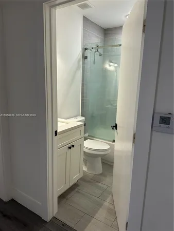 a bathroom with a toilet a sink and shower