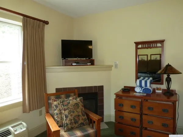 a living room with furniture a flat screen tv and a fireplace