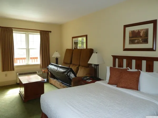 a bedroom with furniture and wooden floor