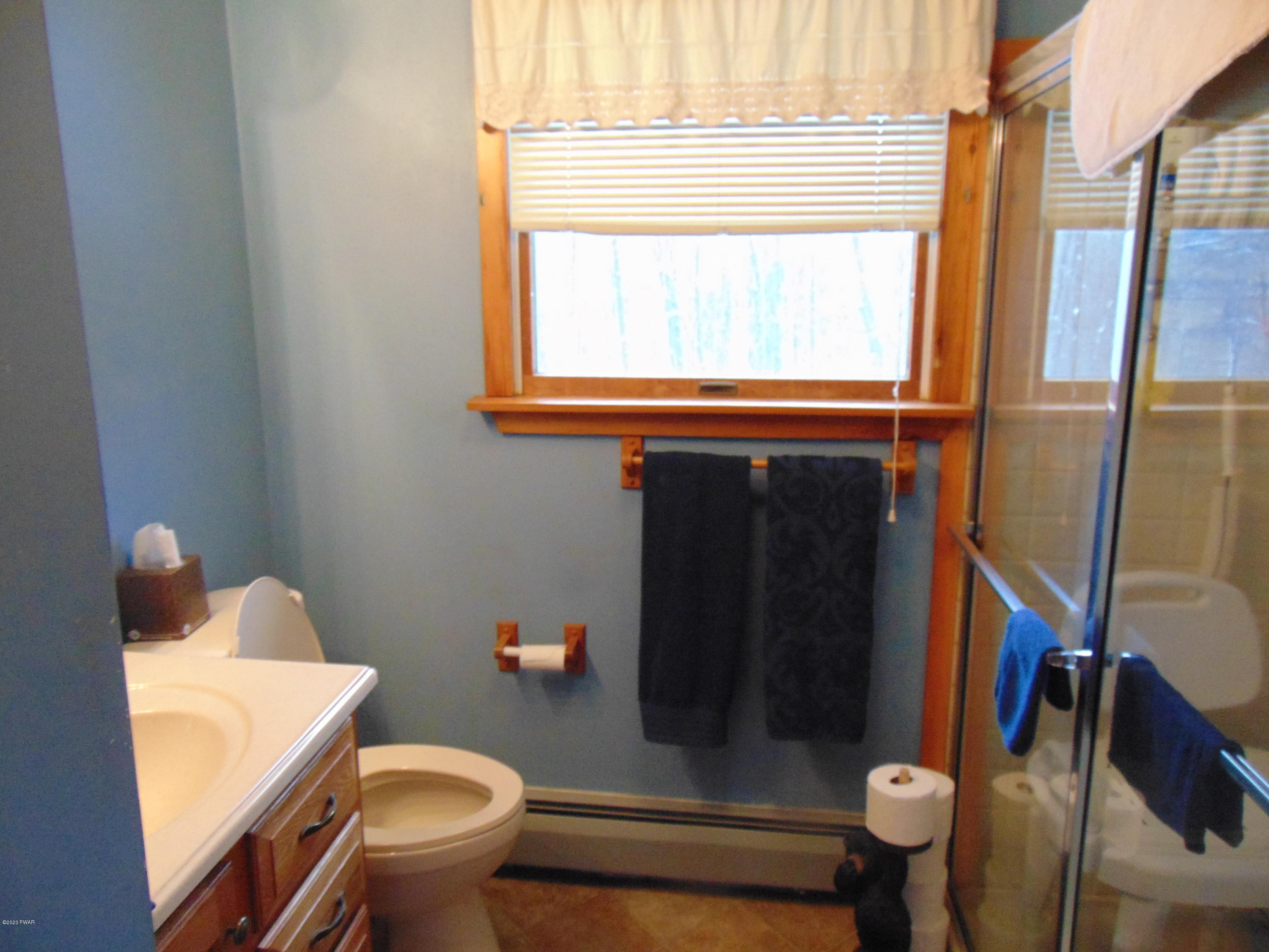 135 Puzo Road Montrose, PA 18801 - Photo 29 of 32 a bathroom with a toilet and a shower curtain