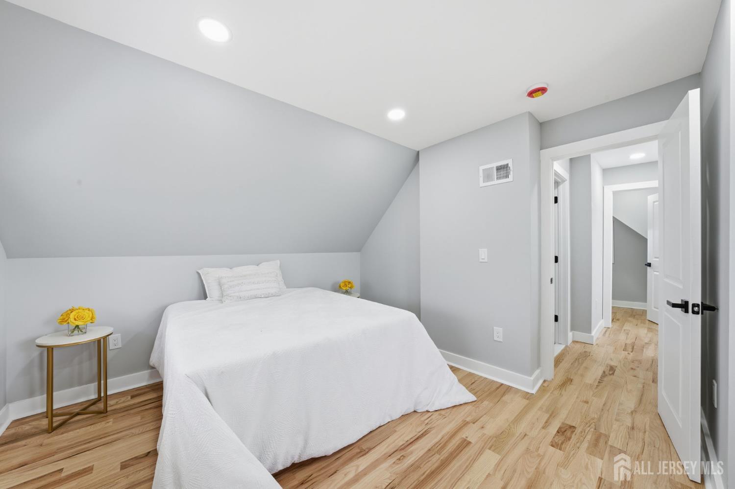 115 Frank Street Somerset, NJ 08873 - Photo 13 of 30 a bedroom with a bed and a chandelier