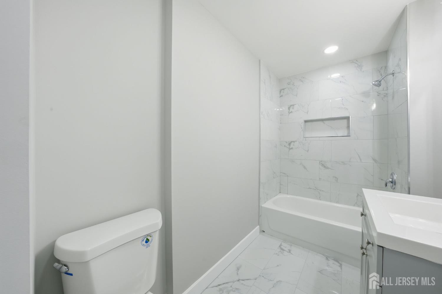 115 Frank Street Somerset, NJ 08873 - Photo 16 of 30 a bathroom with a bathtub and a toilet