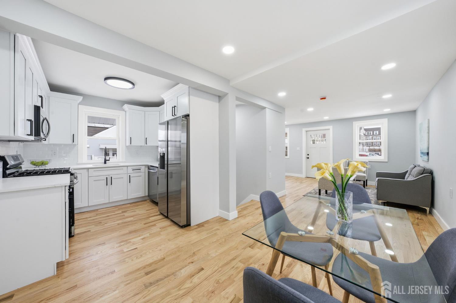 115 Frank Street Somerset, NJ 08873 - Photo 3 of 30 a living room with kitchen island granite countertop furniture and a wooden floor