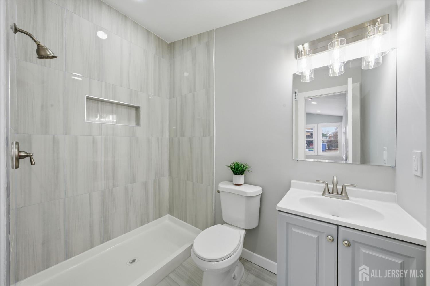 115 Frank Street Somerset, NJ 08873 - Photo 4 of 30 a bathroom with a sink a toilet and shower