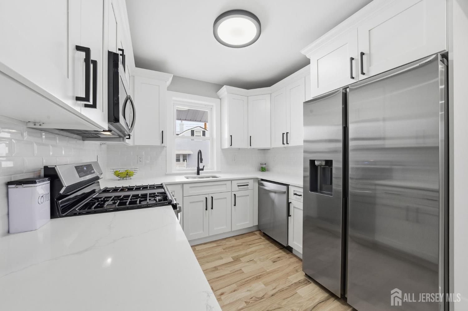 115 Frank Street Somerset, NJ 08873 - Photo 8 of 30 a kitchen with stainless steel appliances granite countertop a refrigerator a sink and white cabinets
