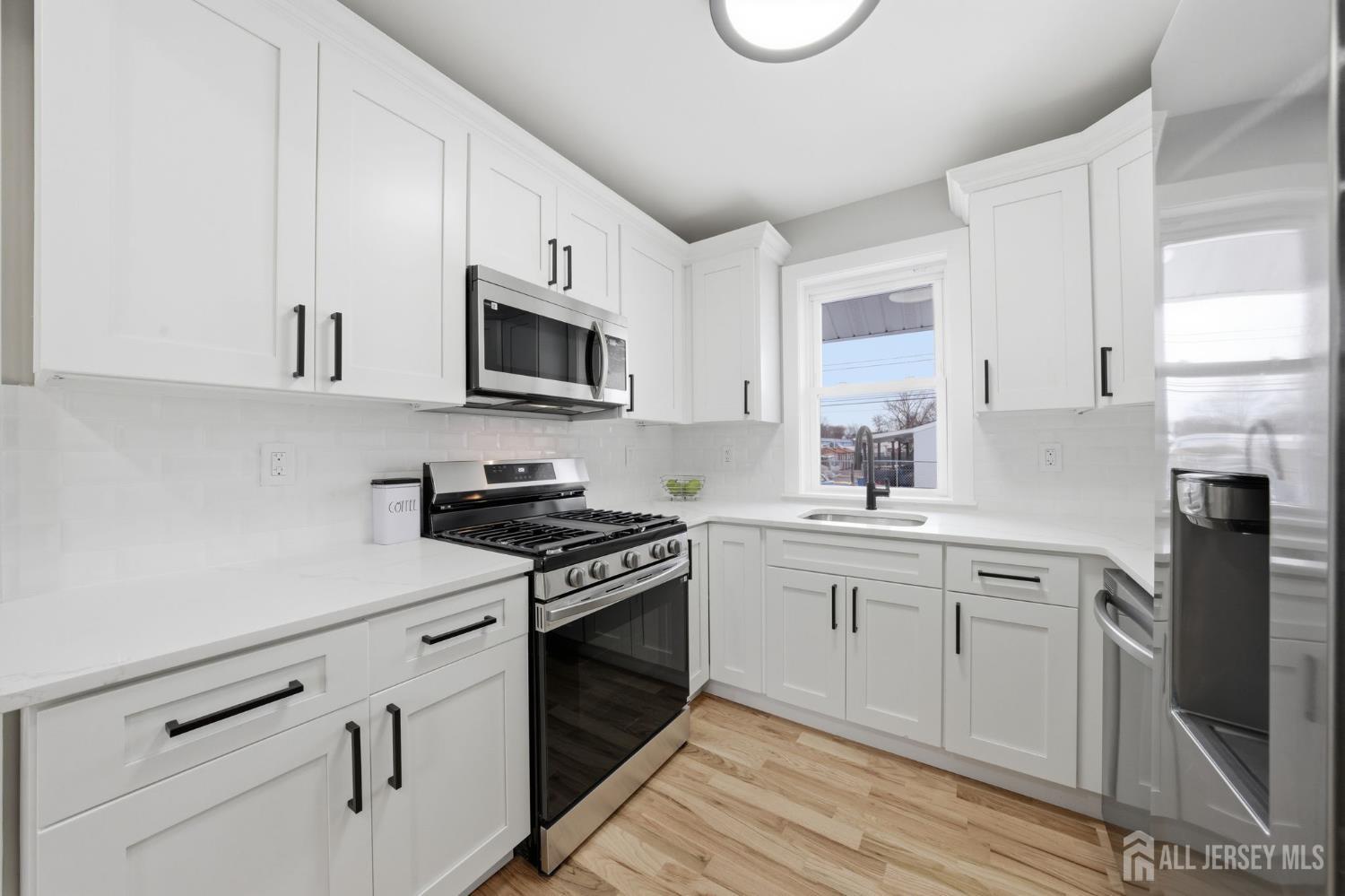 115 Frank Street Somerset, NJ 08873 - Photo 9 of 30 a kitchen with cabinets stainless steel appliances a sink and a stove