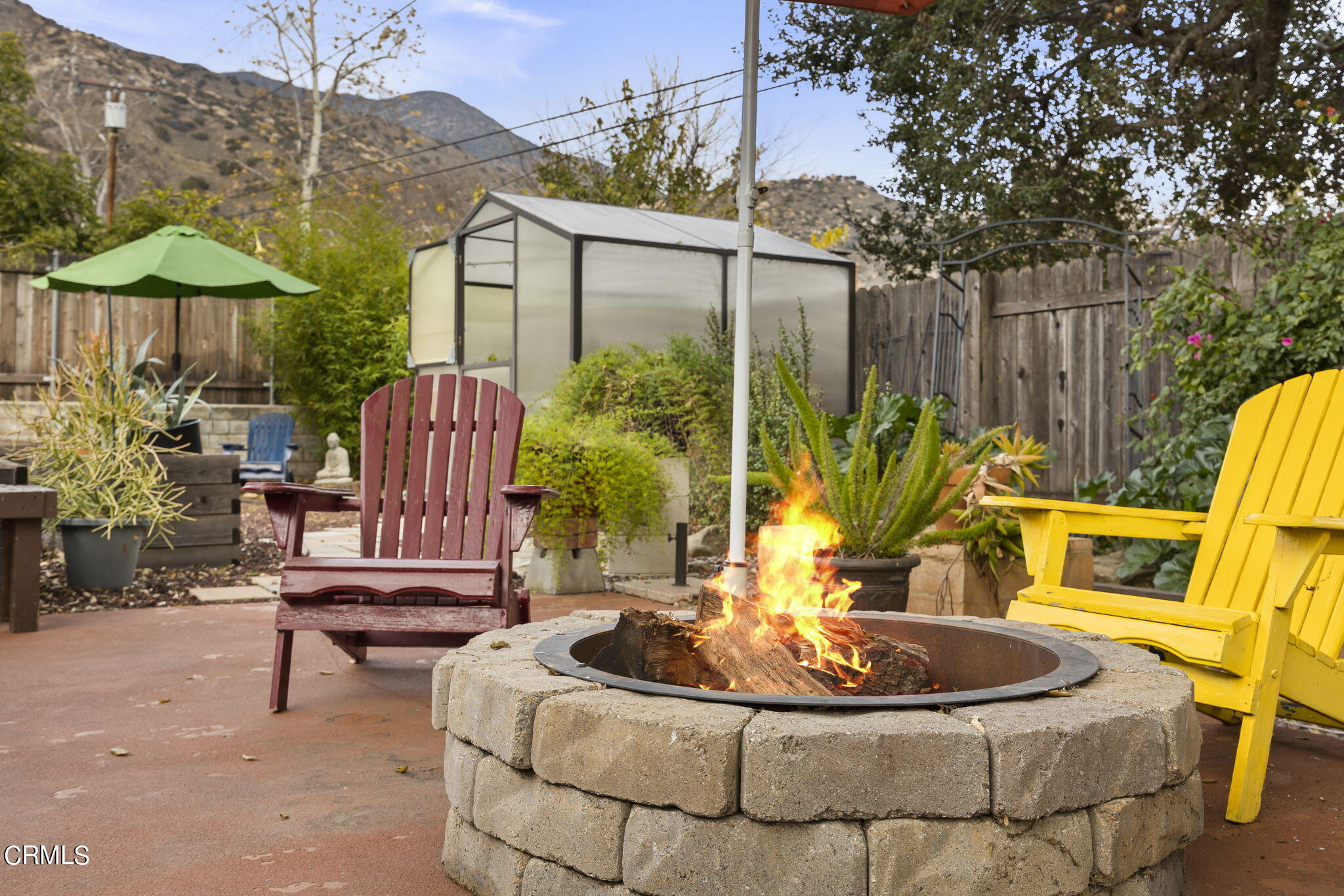 1402 Meadowbrook Road Ojai, CA 93023 - Photo 12 of 31 a view of a patio with table and chairs potted plants and a fountain