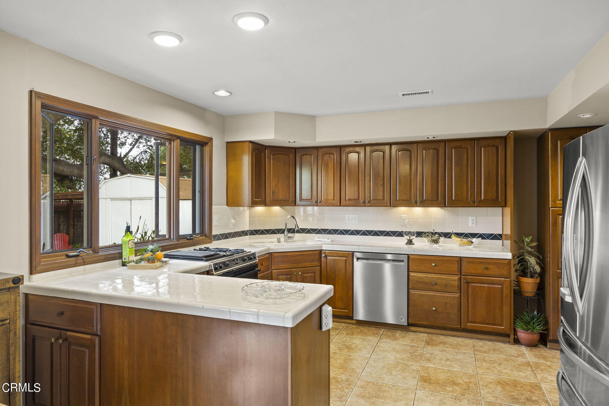 1402 Meadowbrook Road Ojai, CA 93023 - Photo 17 of 31 a kitchen with a stove a sink and a refrigerator