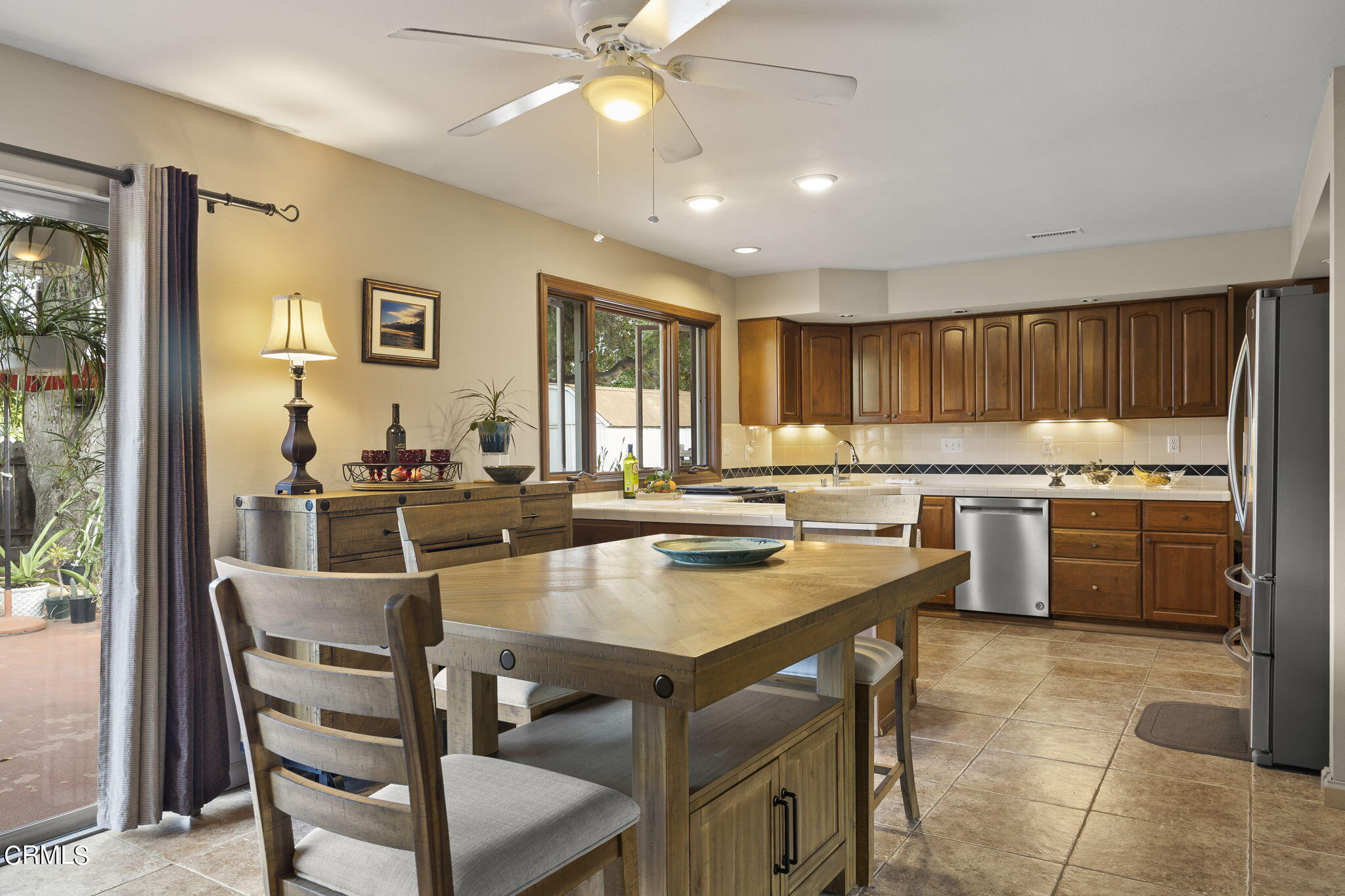 1402 Meadowbrook Road Ojai, CA 93023 - Photo 18 of 31 a kitchen with a table chairs refrigerator and cabinets
