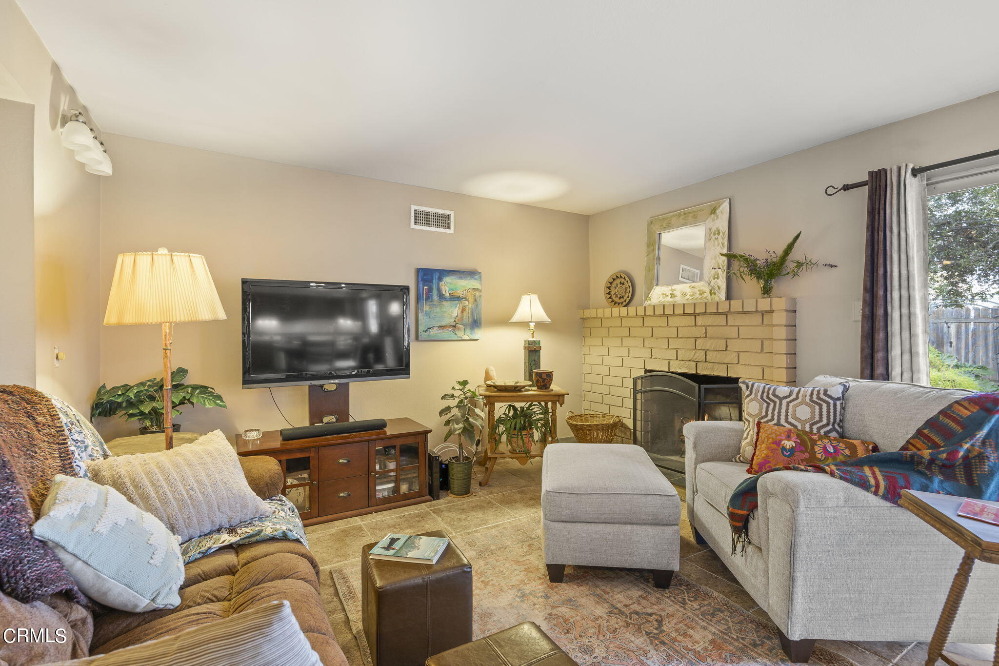1402 Meadowbrook Road Ojai, CA 93023 - Photo 3 of 31 a living room with furniture a fireplace and a flat screen tv