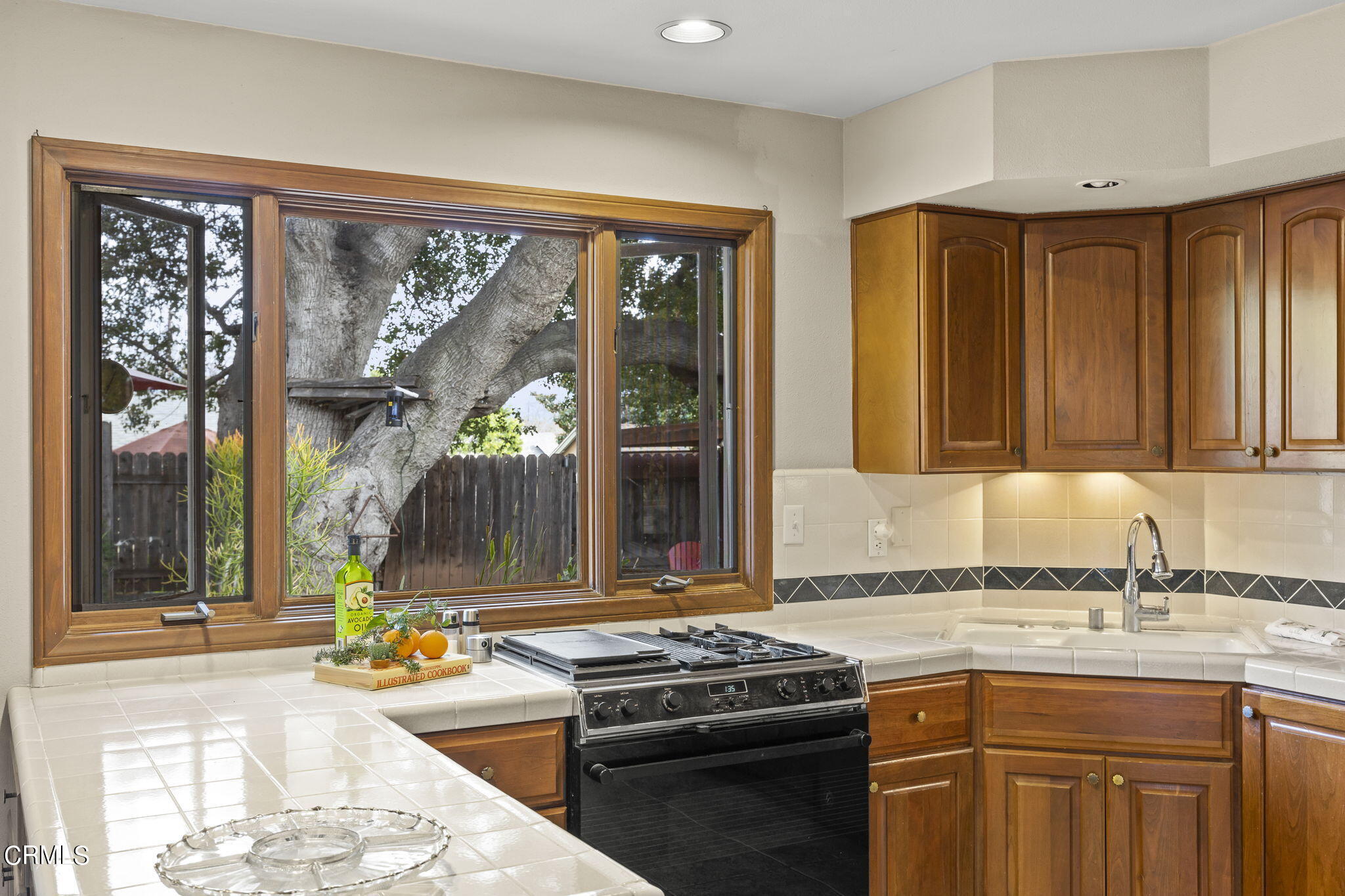 1402 Meadowbrook Road Ojai, CA 93023 - Photo 5 of 31 a kitchen with a stove a sink and a granite counter top
