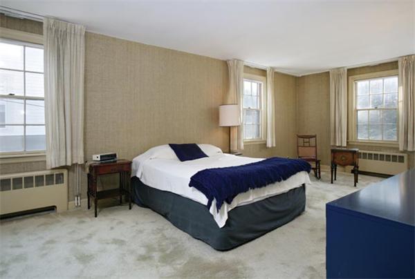 307 Russett Road Brookline, MA 02467 - Photo 5 of 5 a spacious bedroom with a bed and a table in it