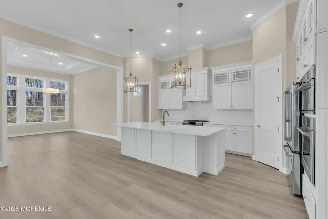 a view of a hallway with wooden floor and a window