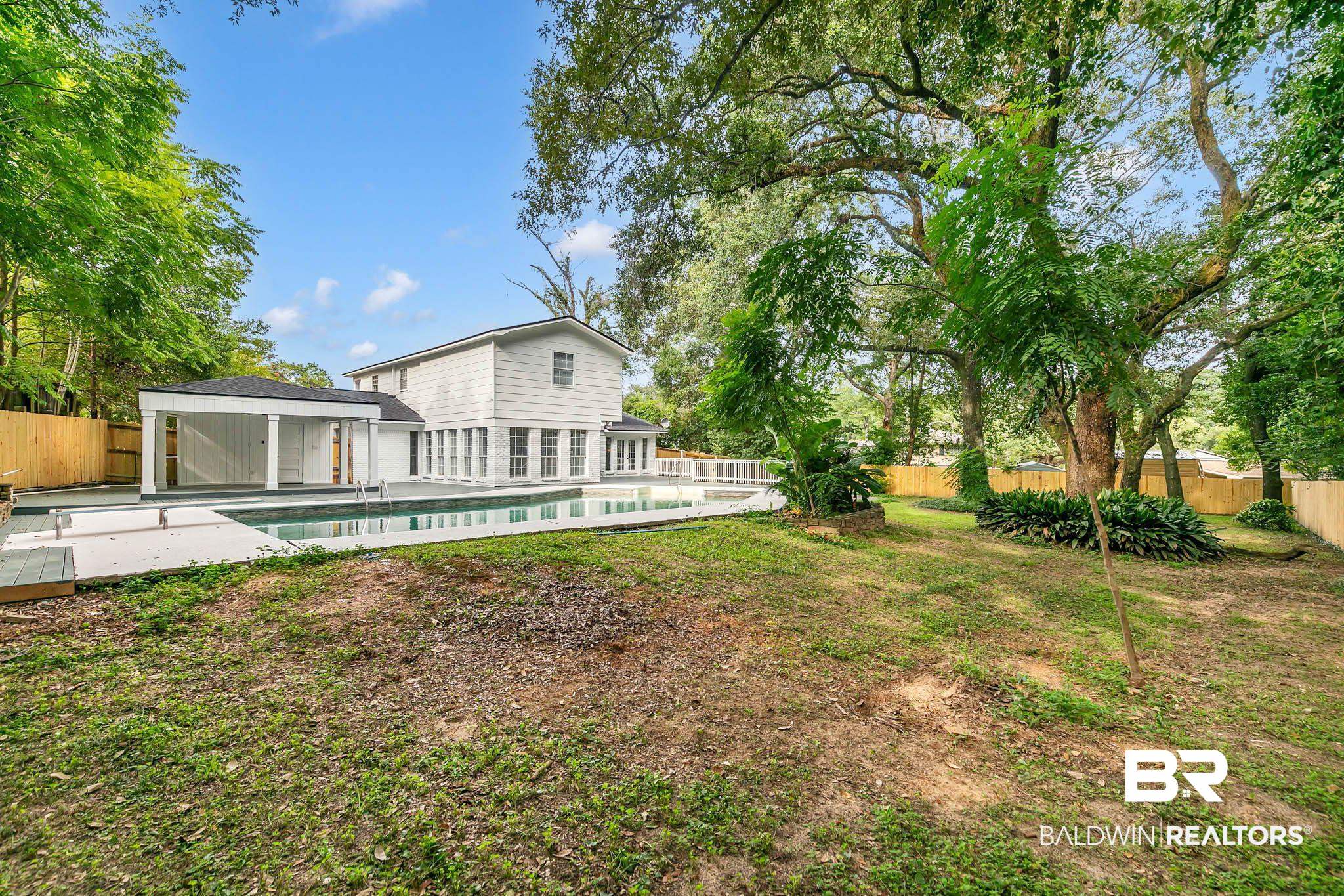4705 Sherry Court Mobile, AL 36693 - Photo 61 of 100 Rear view of house with a fenced backyard, a patio area, and a carport