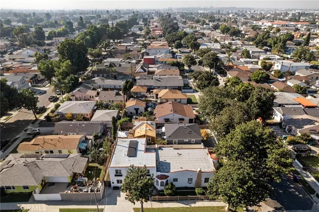 an aerial view of residential houses with outdoor space